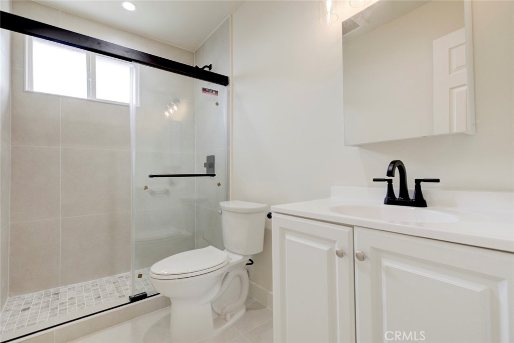9917 Marcus Avenue, Unit 9917 Tujunga, CA 91042 - Photo 23 of 32 a bathroom with a sink a toilet and shower