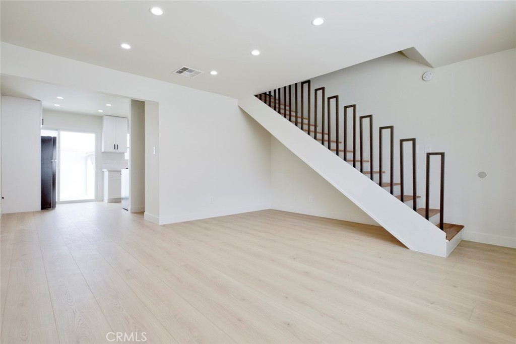 9917 Marcus Avenue, Unit 9917 Tujunga, CA 91042 - Photo 5 of 32 a view of a hallway with wooden floor