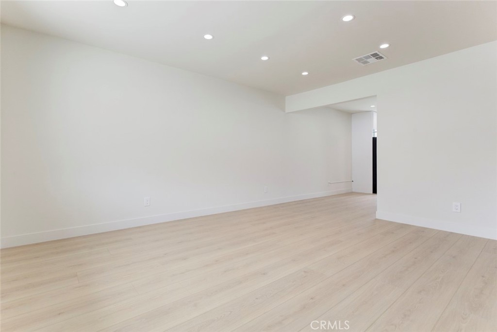 9917 Marcus Avenue, Unit 9917 Tujunga, CA 91042 - Photo 6 of 32 an empty room with wooden floor and windows