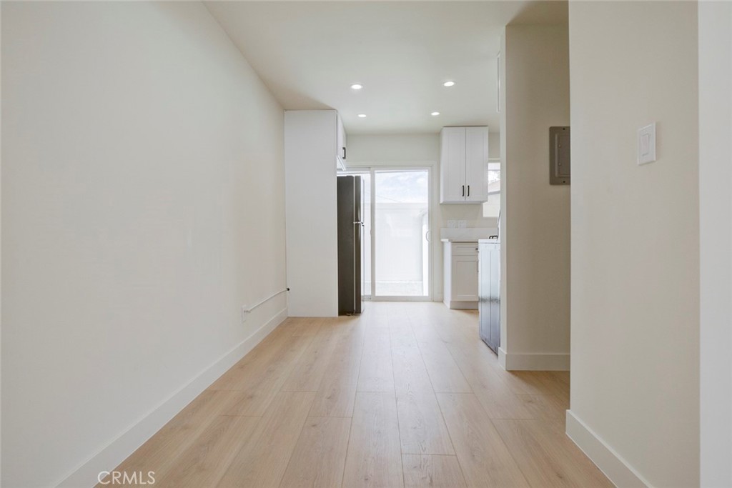 9917 Marcus Avenue, Unit 9917 Tujunga, CA 91042 - Photo 9 of 32 a view of a hallway with wooden floor and a refrigerator