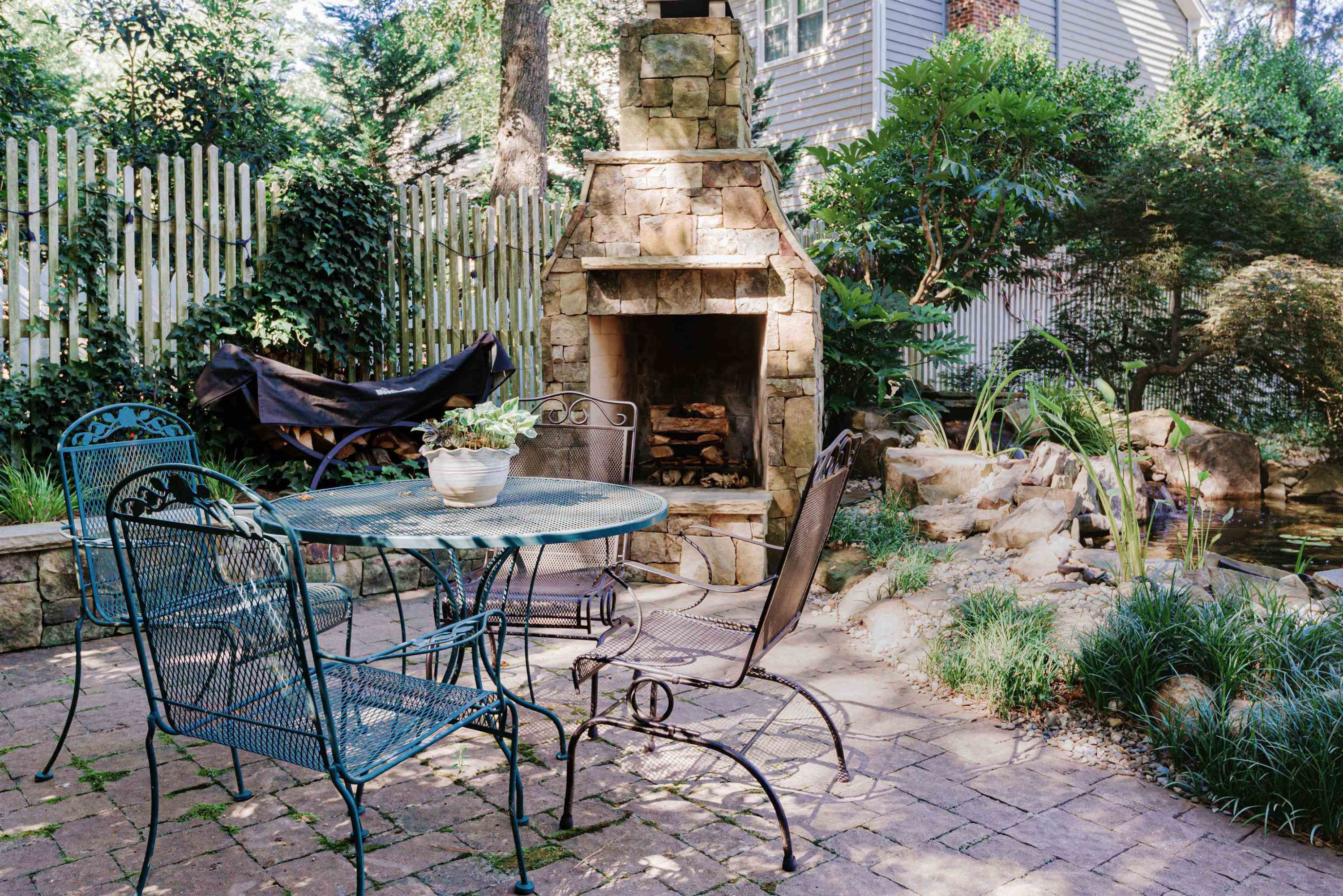 6928 Slade Hill Road Raleigh, NC 27615 - Photo 43 of 46 Stone fireplace and patio relax and enjoy the stocked Koi Pond Backyard Fireplace and Patio