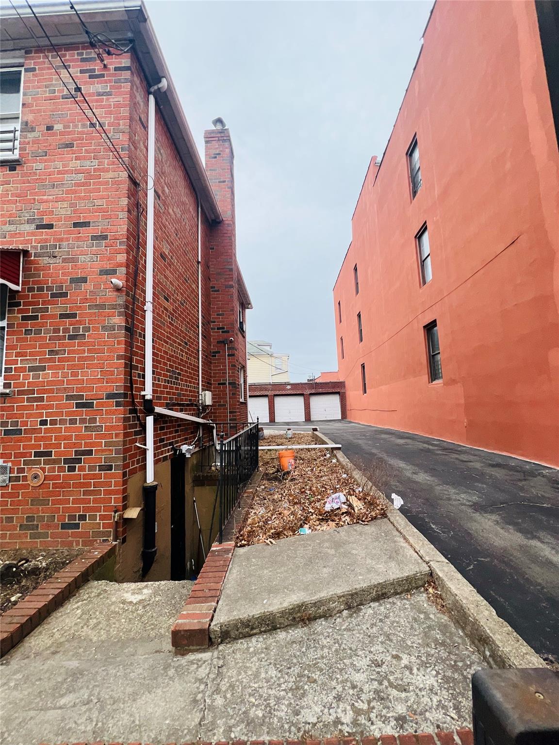 1723 Seddon Street Bronx, NY 10461 - Photo 6 of 6 View of home's exterior featuring brick siding and a garage