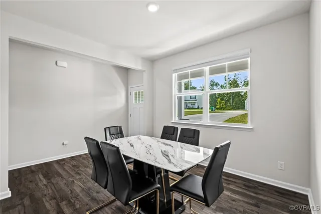 a view of a dining room with a table and chairs