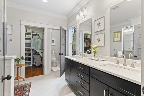 a en suite bathroom with a double vanity sink and a mirror