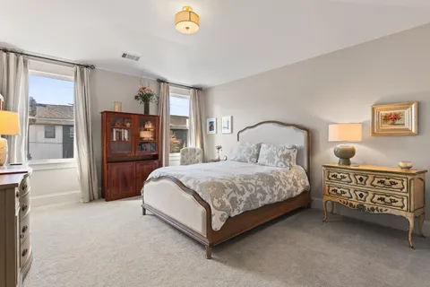 a bedroom with a bed next to a window
