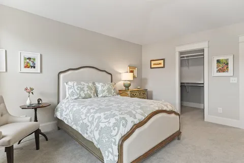 a bedroom with a bed and a lamp on table