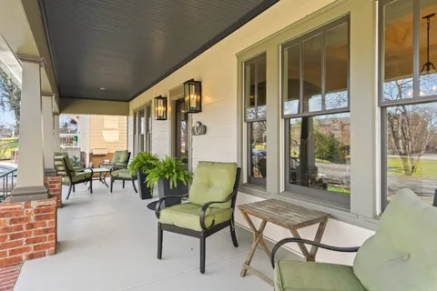 a building outdoor space with patio furniture and potted plants