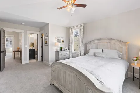 a bedroom with a bed and a chandelier