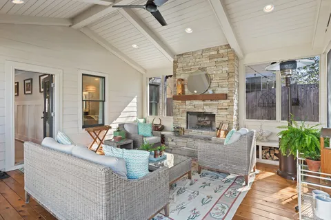 a living room with furniture large window and a fireplace