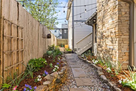 a view of a pathway of a house with a yard