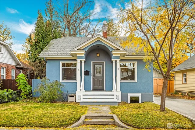a front view of a house with a garden