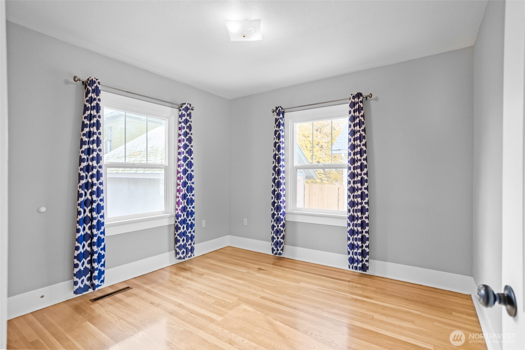 8 Newell Street Walla Walla, WA 99362 - Photo 12 of 22 a view of empty room with window and wooden floor