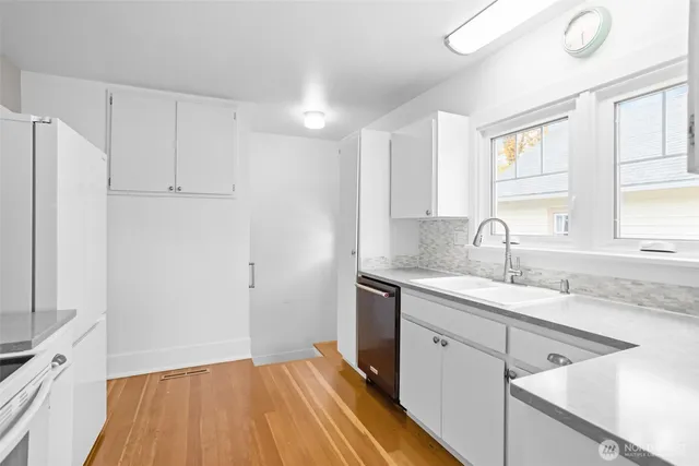 a kitchen with stainless steel appliances a stove microwave and sink