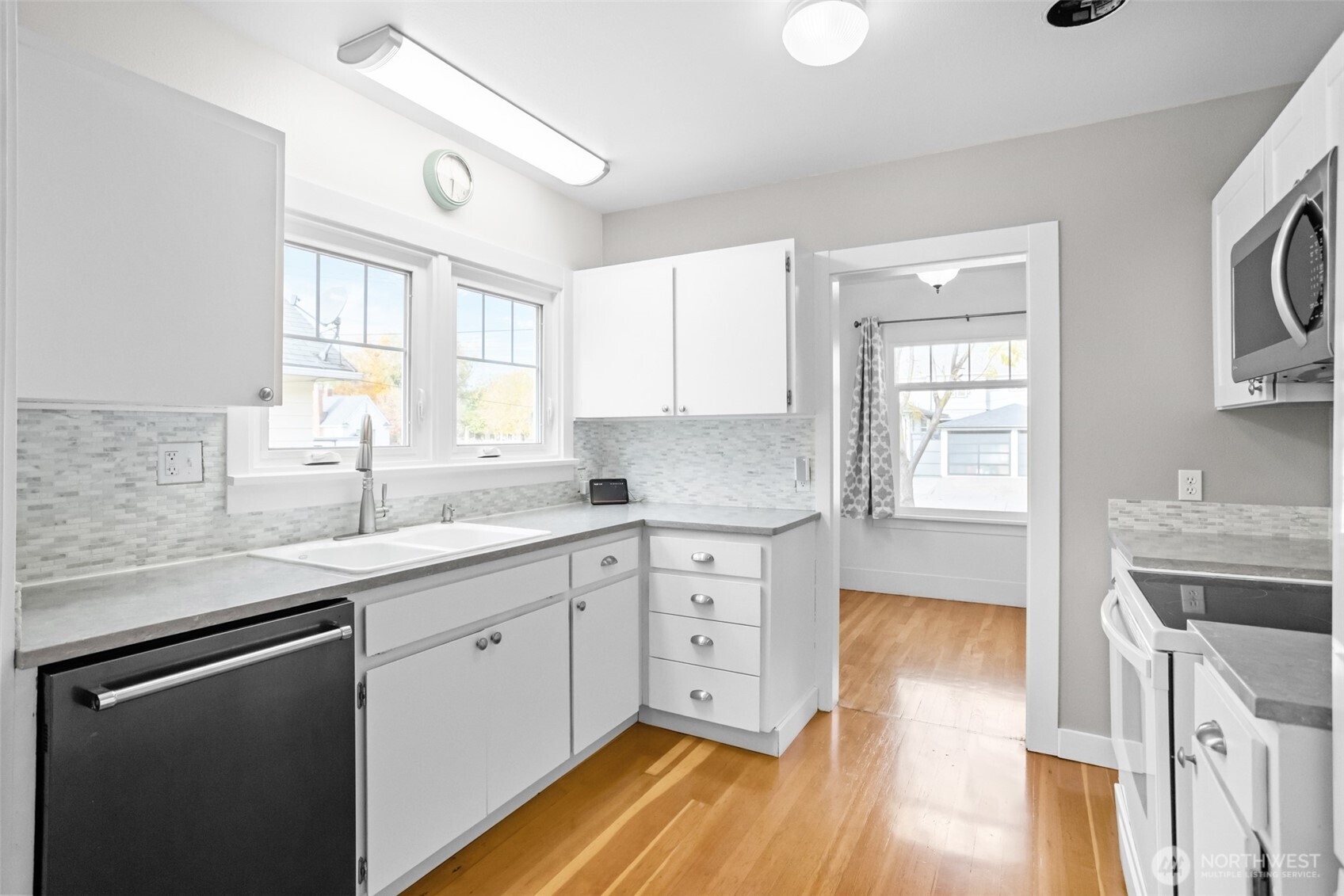 8 Newell Street Walla Walla, WA 99362 - Photo 7 of 22 a kitchen with granite countertop white cabinets and white appliances