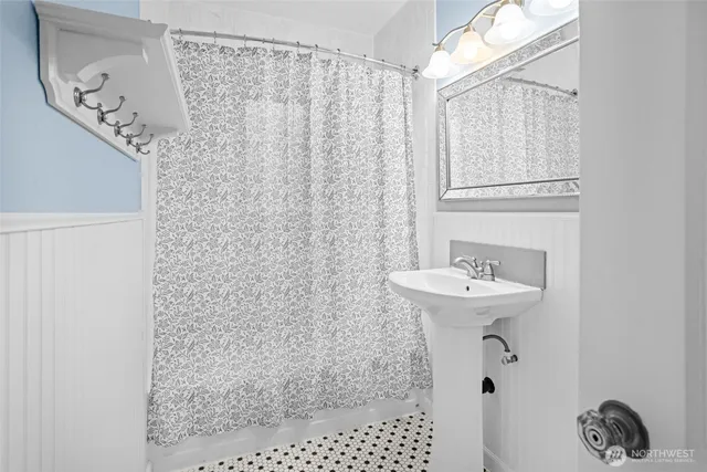 a bathroom with a sink toilet and a mirror