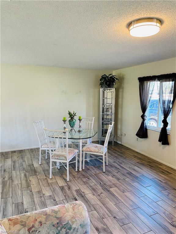 19040 Tampa Road South Fort Myers, FL 33967 - Photo 2 of 23 a dining room with furniture and wooden floor