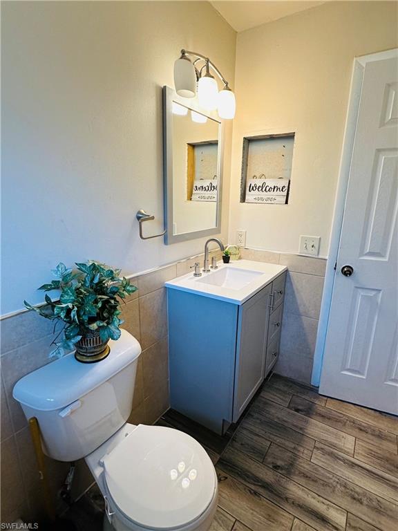 19040 Tampa Road South Fort Myers, FL 33967 - Photo 21 of 23 a bathroom with a toilet a sink and mirror