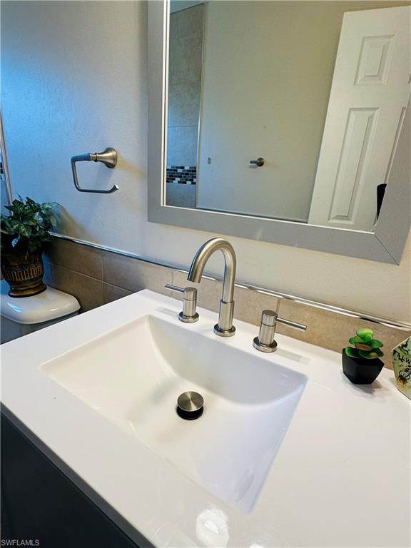 19040 Tampa Road South Fort Myers, FL 33967 - Photo 22 of 23 a bathroom with a sink and a mirror