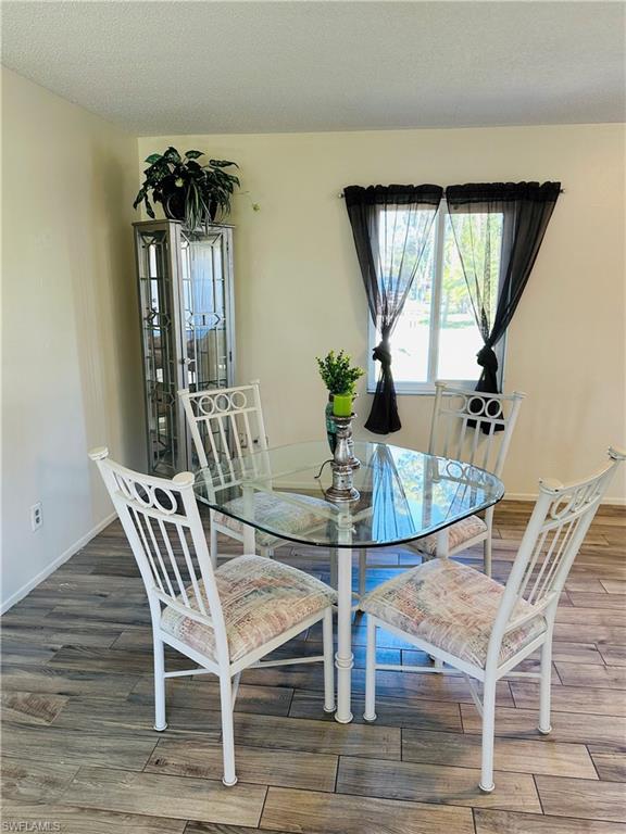 19040 Tampa Road South Fort Myers, FL 33967 - Photo 3 of 23 a view of a dining room with furniture and wooden floor