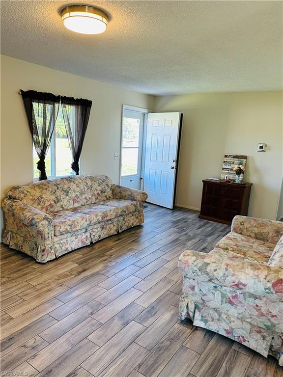 19040 Tampa Road South Fort Myers, FL 33967 - Photo 4 of 23 a bedroom with a bed and wooden floor