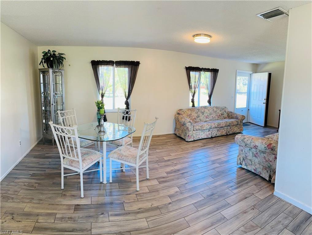 19040 Tampa Road South Fort Myers, FL 33967 - Photo 6 of 23 a living room with furniture and wooden floor