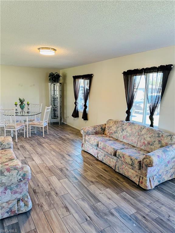 19040 Tampa Road South Fort Myers, FL 33967 - Photo 9 of 23 a bedroom with a bed and wooden floor
