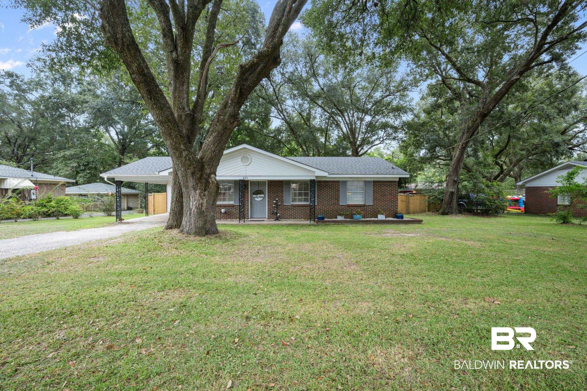 621 Ann Street Saraland, AL 36571 - Photo 2 of 21 Ranch-style home with a carport and a front lawn