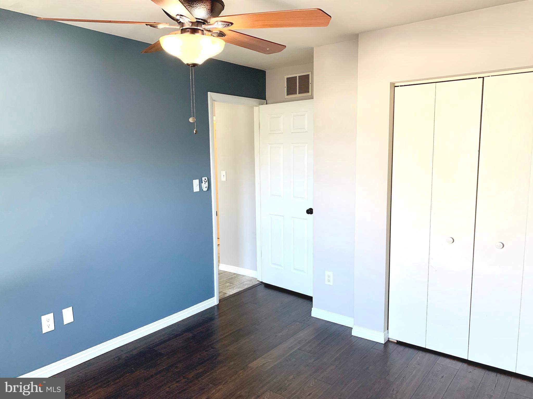 808 207th Street Pasadena, MD 21122 - Photo 12 of 20 a view of a livingroom with a ceiling fan and wooden floor