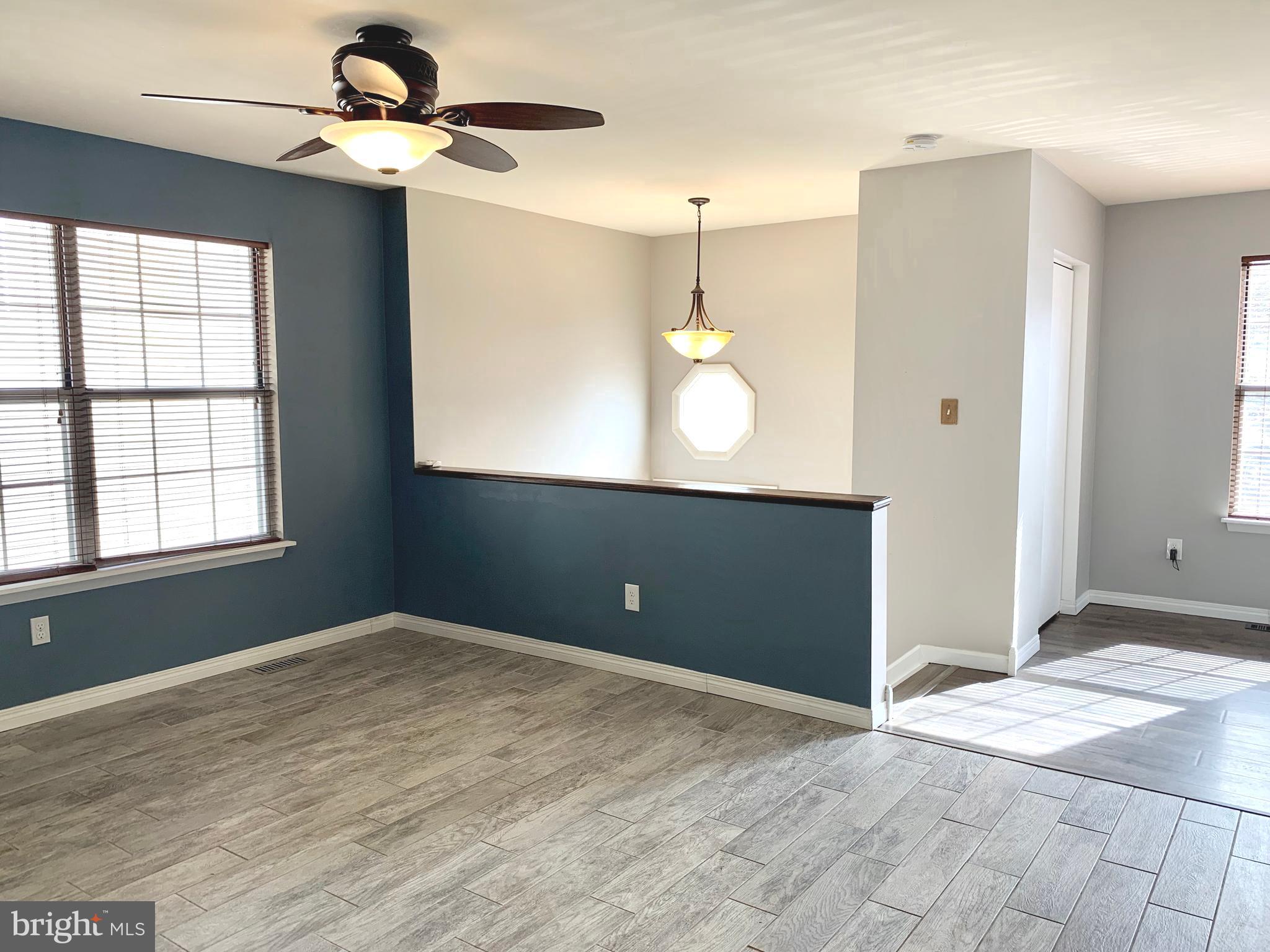 808 207th Street Pasadena, MD 21122 - Photo 2 of 20 a view of an empty room with window and wooden floor