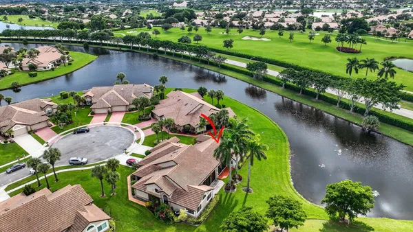 an aerial view of a house with a lake view and a large pool