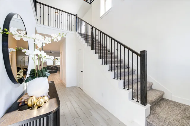 a view of entryway and hall with wooden floor