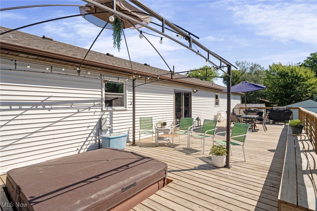 9208 Thorpe Road Berlin Heights, OH 44814 - Photo 39 of 47 Wooden terrace featuring outdoor dining area and a covered hot tub