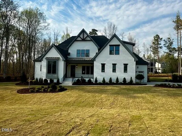 a front view of a house with swimming pool and porch