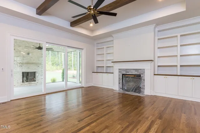 a view of staircase with wooden floor and fan
