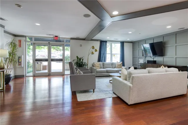 a living room with furniture a dining table and a large window