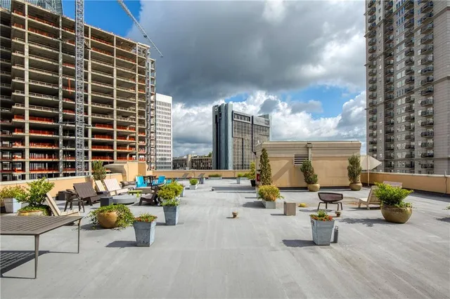 a view of a patio with dining table and chairs