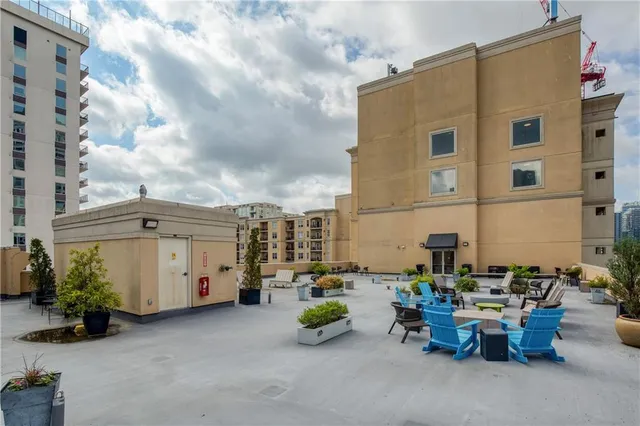 a view of a patio with dining table and chairs with potted plants
