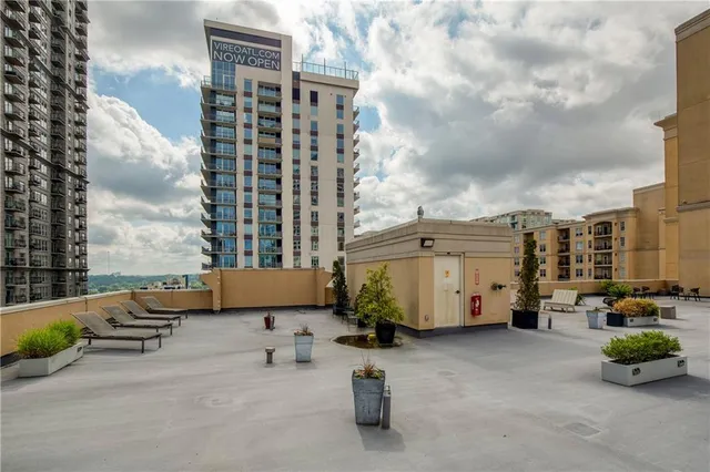 a backyard of a house with outdoor seating and a potted plant