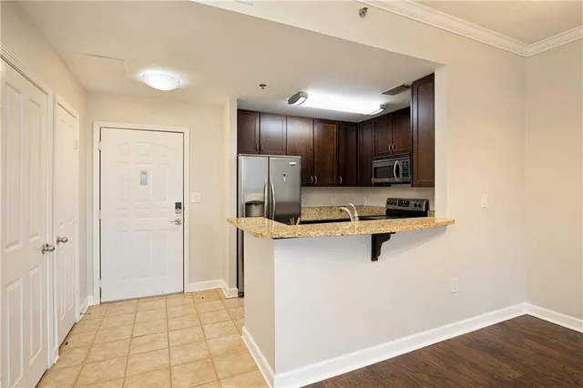 a view of a kitchen with wooden floor and a sink