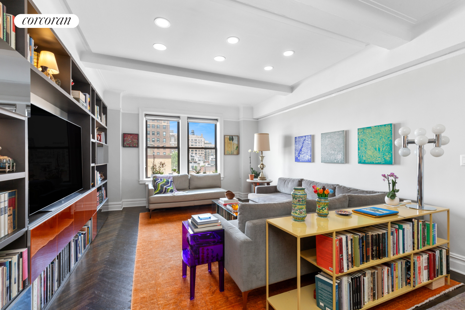 a dining room with stainless steel appliances granite countertop a couch and a flat screen tv