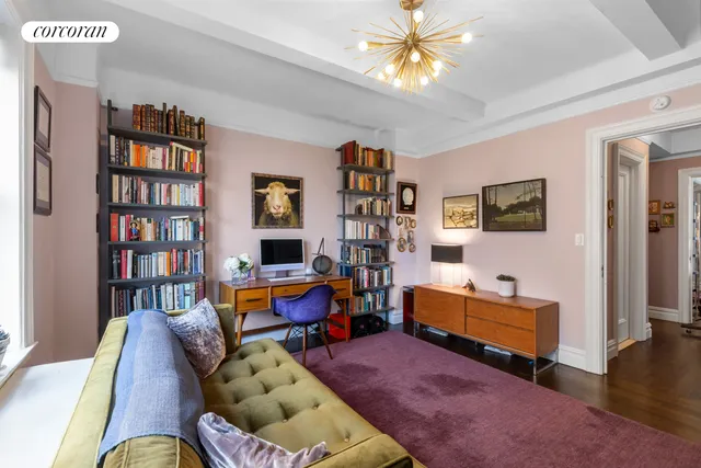 a living room with furniture and a book shelf