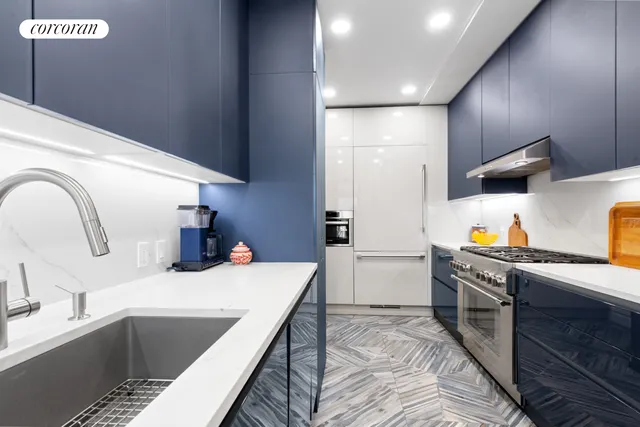 a kitchen with a sink and a stove top oven