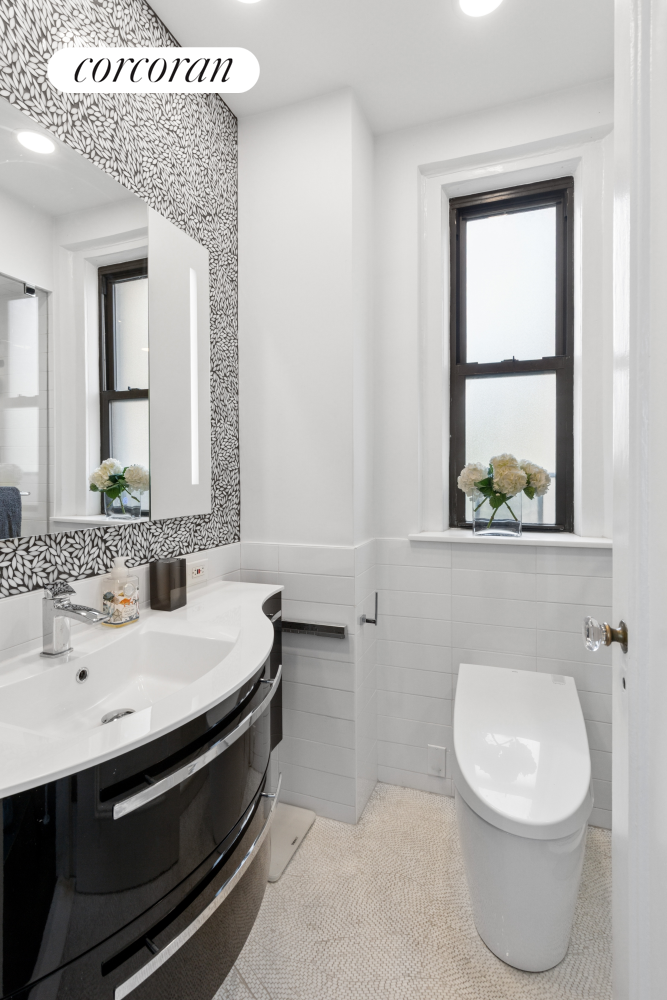 340 Riverside Drive, Unit 8C Manhattan, NY 10025 - Photo 8 of 12 a bathroom with a sink a toilet and mirror