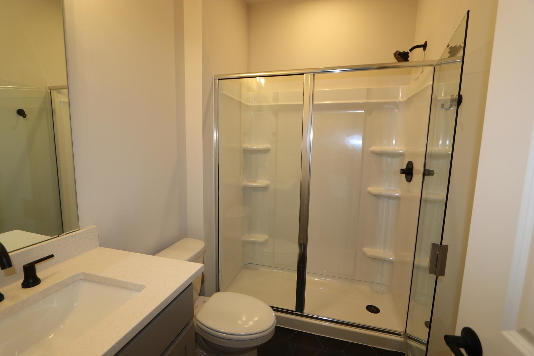 716 Icarus Lane Wake Forest, NC 27587 - Photo 5 of 5 a bathroom with a shower a toilet and sink