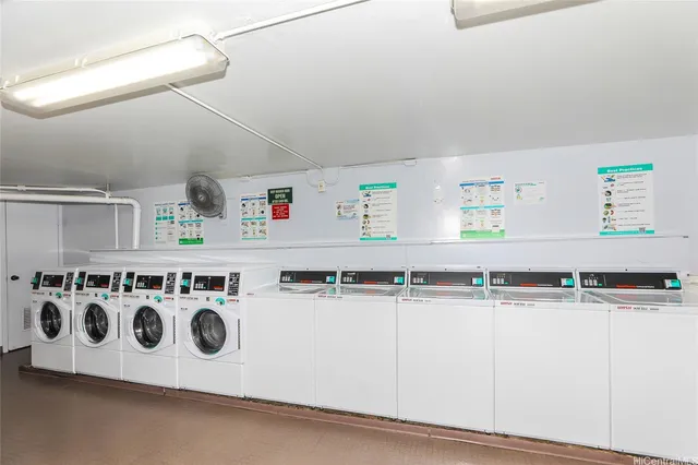a kitchen with stainless steel appliances granite countertop a sink and a white cabinets