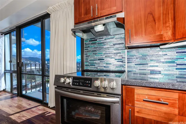 a kitchen with granite countertop stainless steel appliances and wooden cabinets