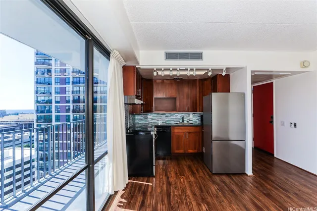 a kitchen with stainless steel appliances granite countertop a refrigerator and a stove