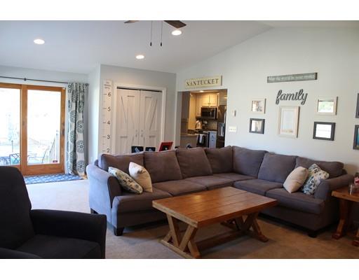 1 Wenzell Road Ashland, MA 01721 - Photo 11 of 20 a living room with furniture a large window and a flat screen tv