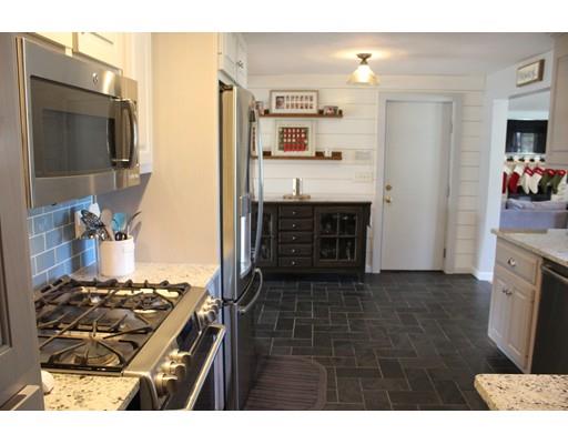 1 Wenzell Road Ashland, MA 01721 - Photo 10 of 20 a kitchen with kitchen island granite countertop a stove and a sink