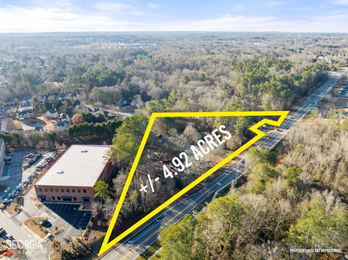 a view of swimming pool with a garden and patio